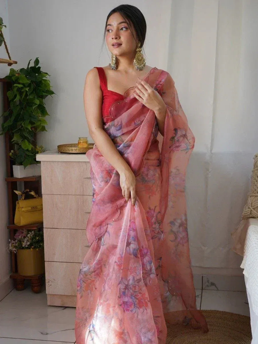 Woman in pink floral saree with red blouse, ethnic Indian wear, designer saree style