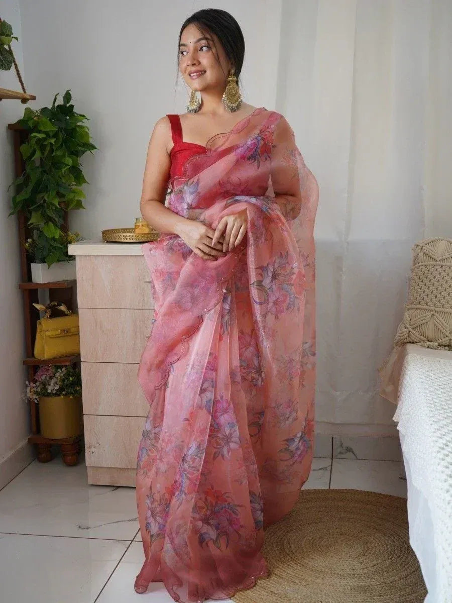 Woman in pink floral saree with red blouse, ethnic Indian wear for festive occasions