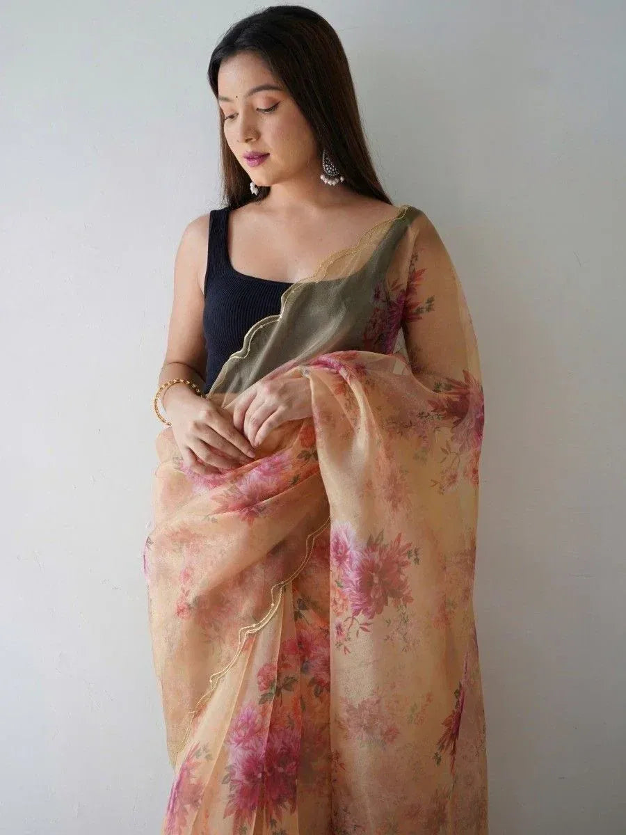 Woman in floral print saree with gold border, styled with black top for ethnic wear