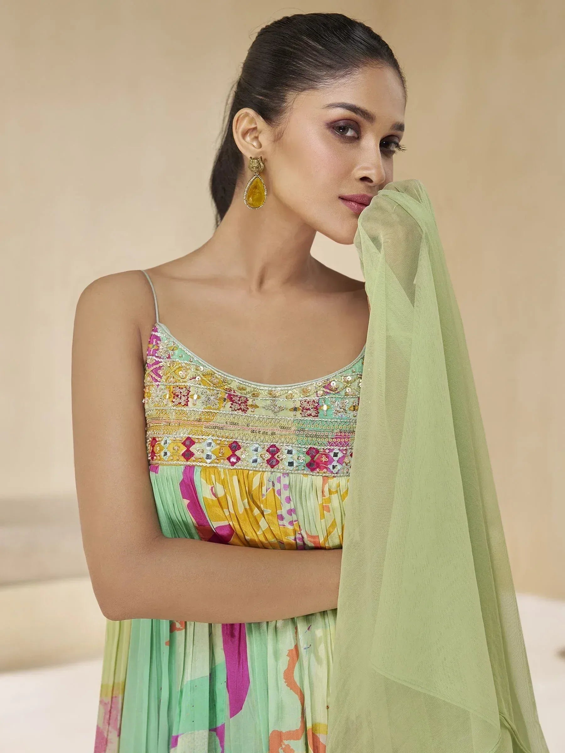 Woman in colorful embroidered ethnic gown with green dupatta, perfect for Indian occasions