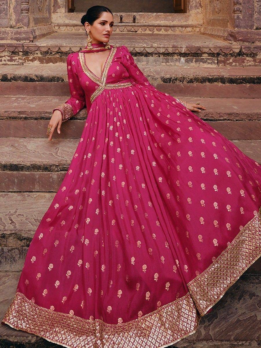 Pink ethnic gown with gold floral embroidery, perfect for Indian weddings or festive occasions.