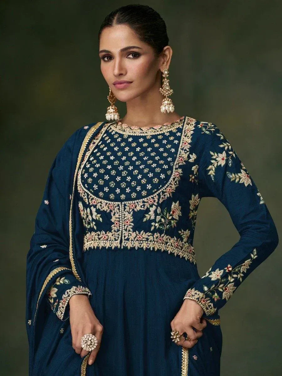 Elegant navy blue embroidered ethnic gown with floral detailing and gold trim, perfect for Indian occasions.