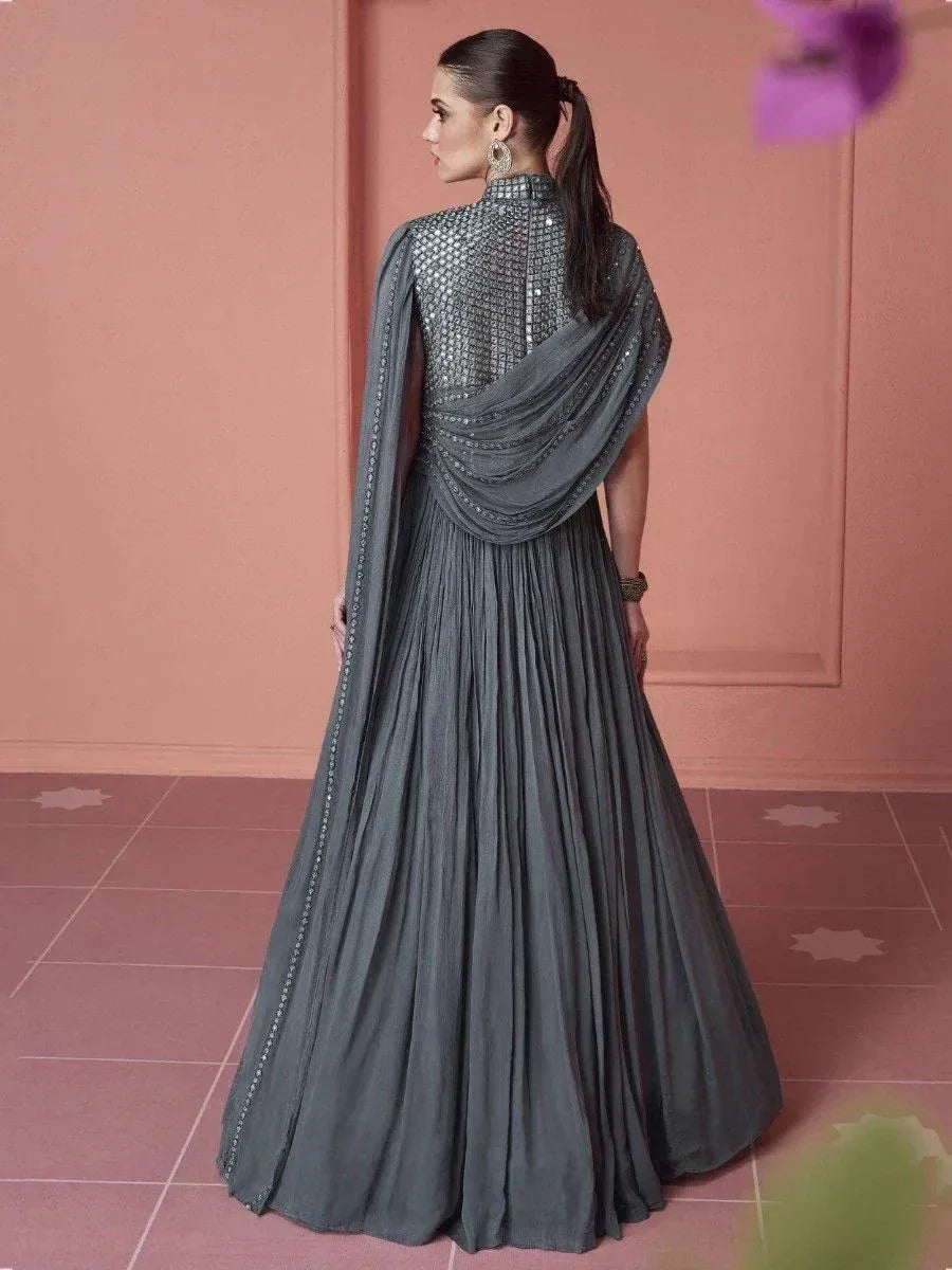 Woman in an elegant grey ethnic gown with mirror work and draped dupatta, back view