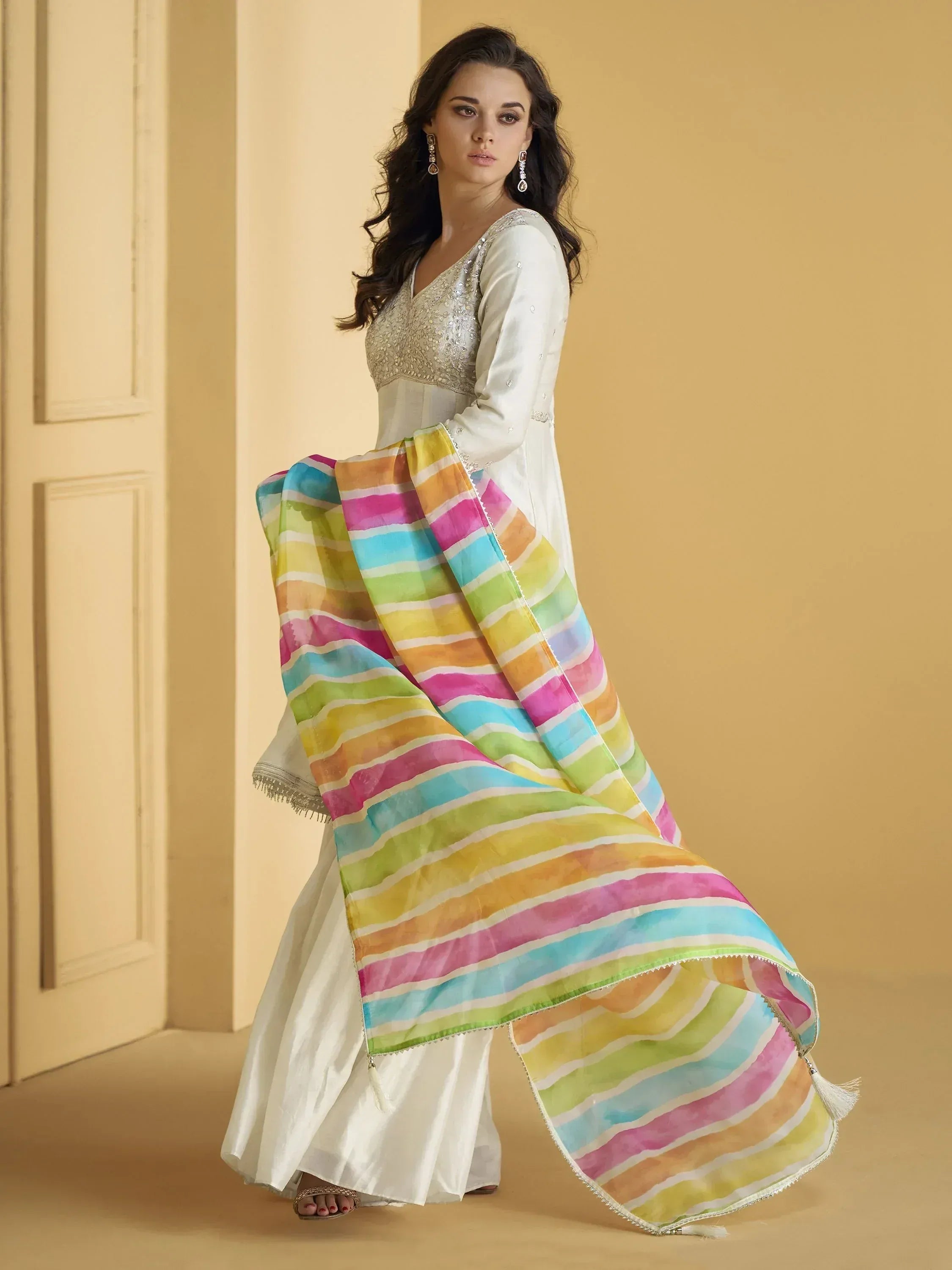 Woman in white embroidered kurta with rainbow striped dupatta, Indian ethnic wear