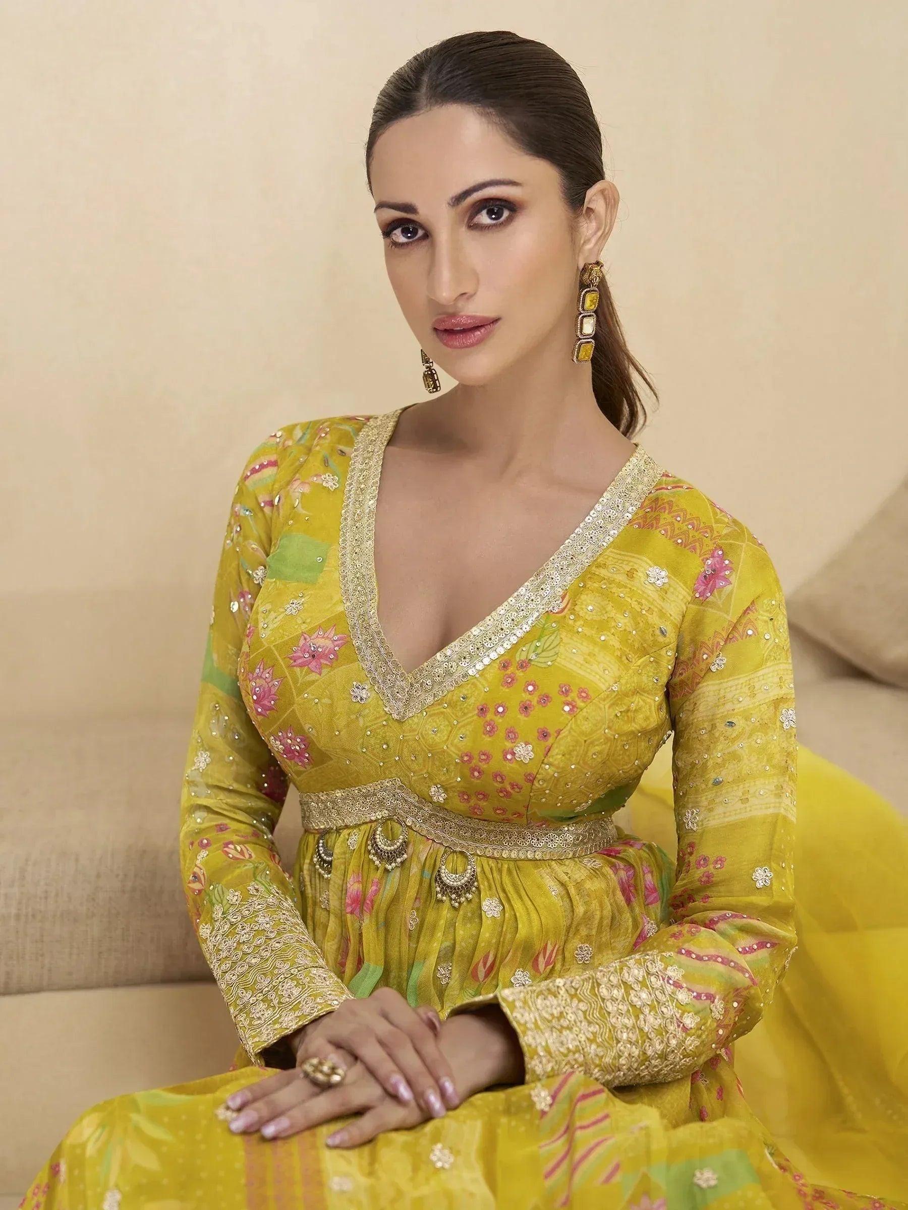 Yellow floral ethnic gown with gold embroidery and embellished neckline, perfect for Indian celebrations