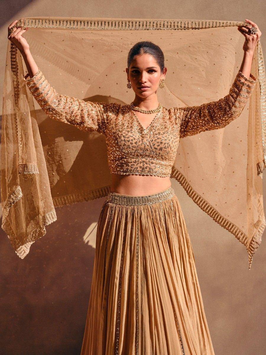 Elegant gold embroidered lehenga choli with matching dupatta, perfect for Indian ethnic wear occasions