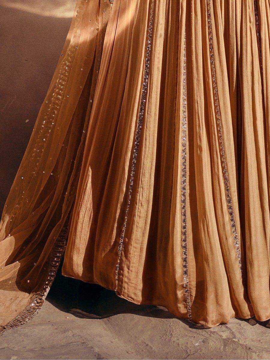Golden pleated lehenga with intricate embroidery and sheer dupatta, perfect for Indian ethnic wear