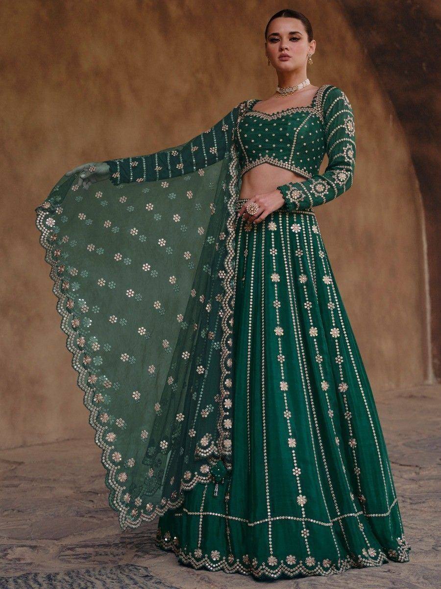Emerald green designer lehenga choli with floral embroidery and sheer dupatta, perfect for weddings and festivals.