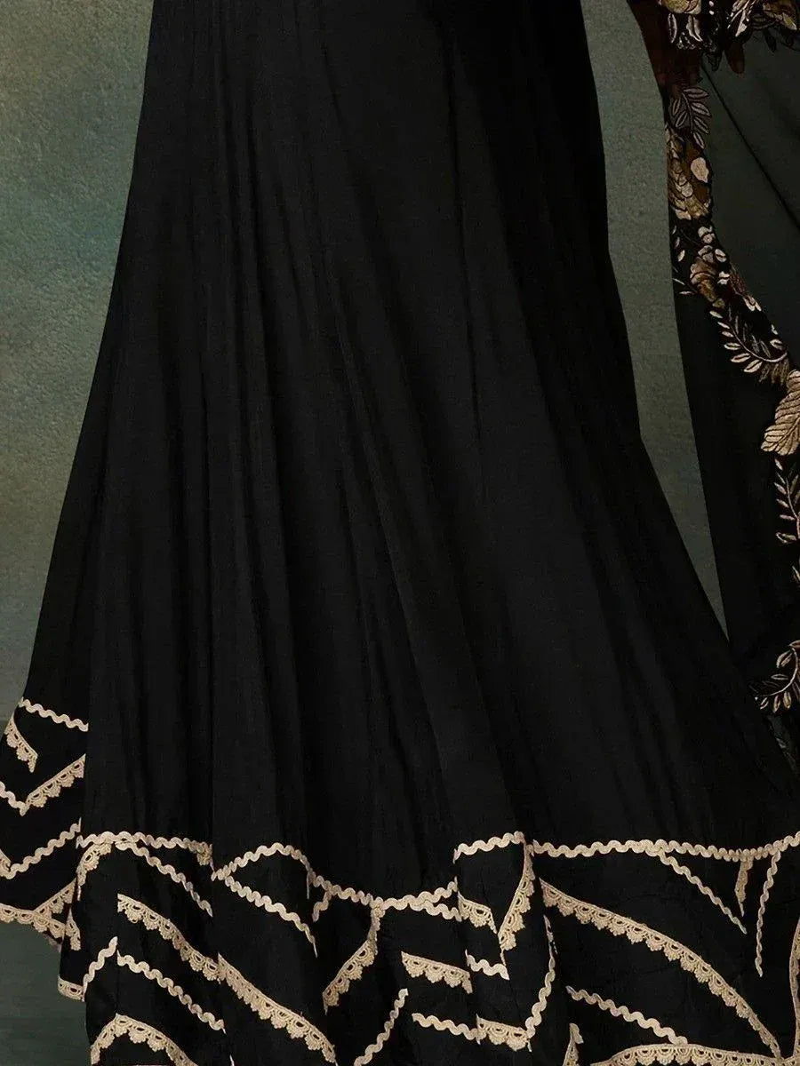 Black ethnic gown with gold lace detailing, perfect for Indian festive occasions and weddings.