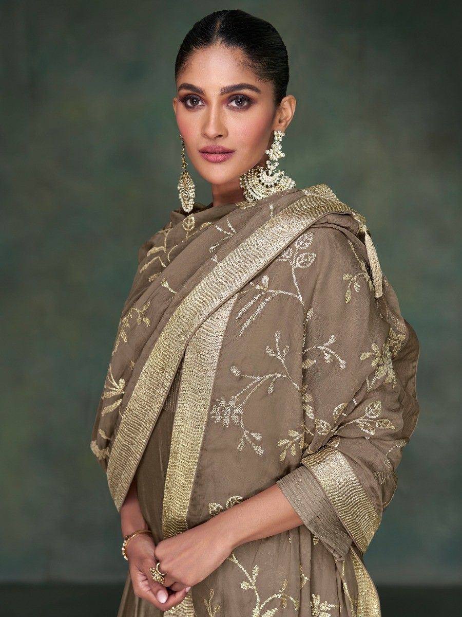 Elegant olive green saree with gold floral embroidery and border, paired with statement jewelry for Indian ethnic wear.