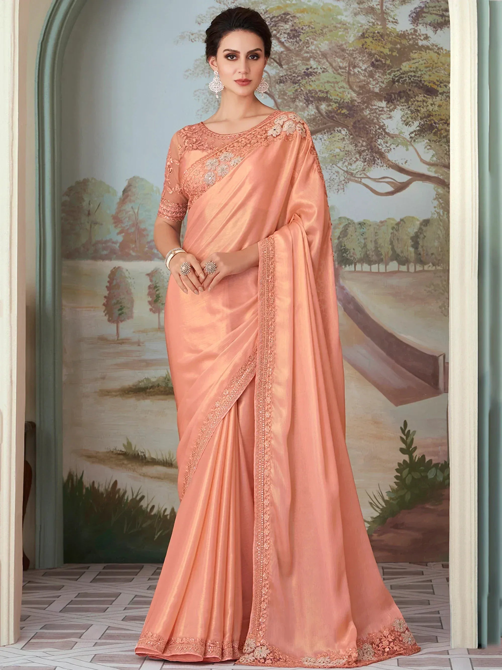 Elegant peach saree with floral embroidery and lace detailing, perfect for Indian ethnic occasions