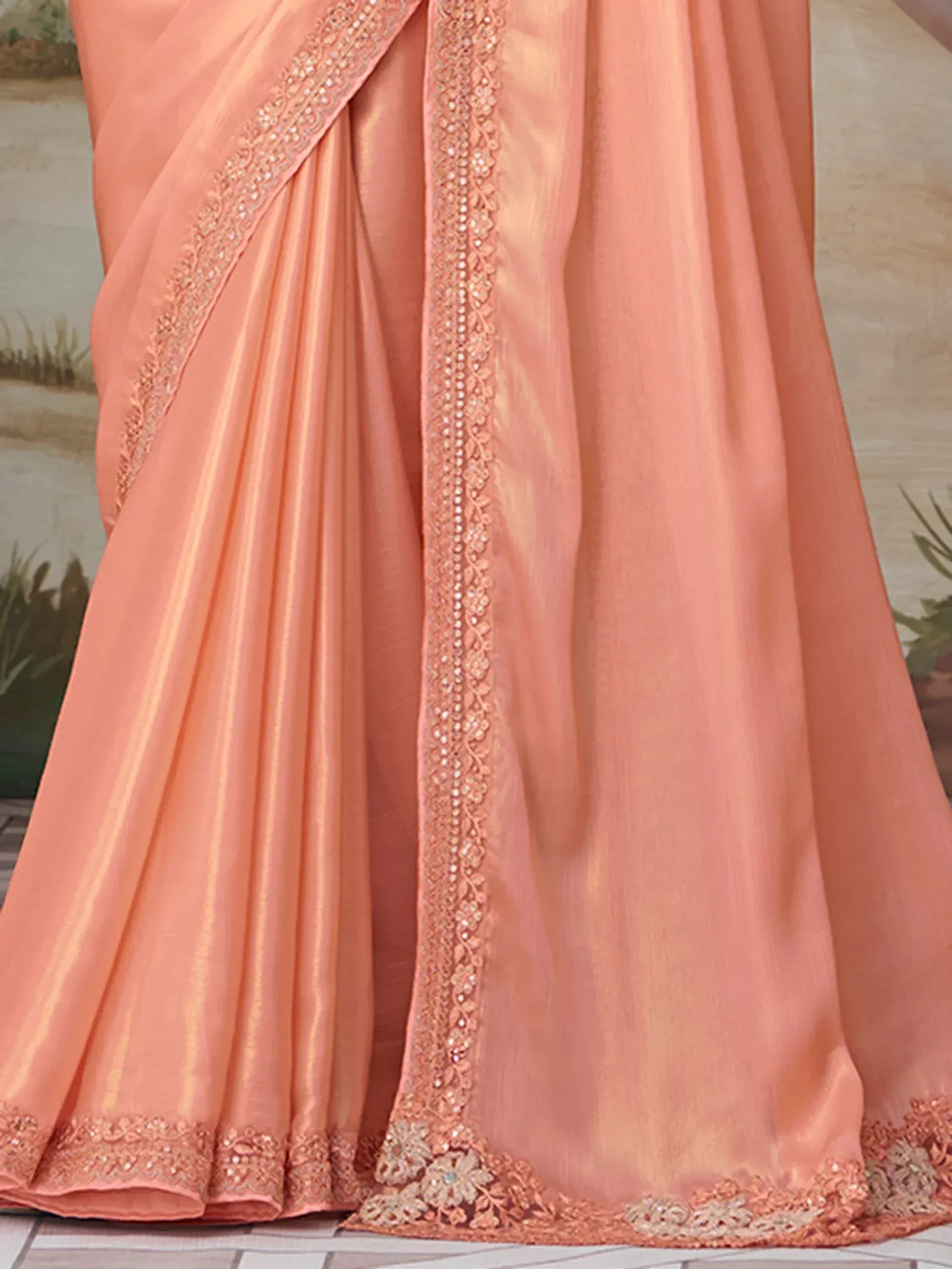 Peach saree with intricate embroidery and sequin border, elegant Indian ethnic wear