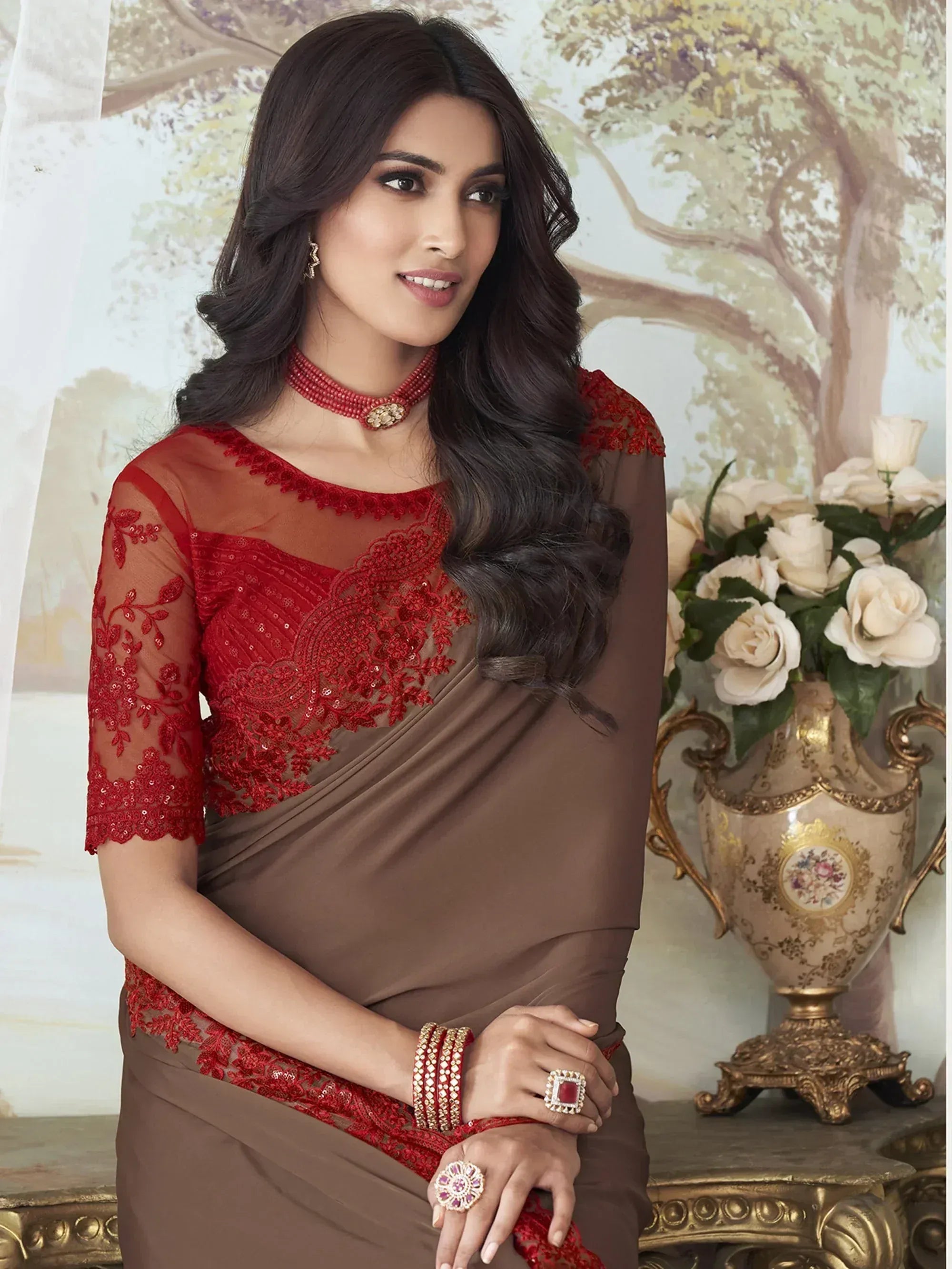 Elegant brown saree with red lace blouse, perfect for Indian ethnic occasions and festive wear.