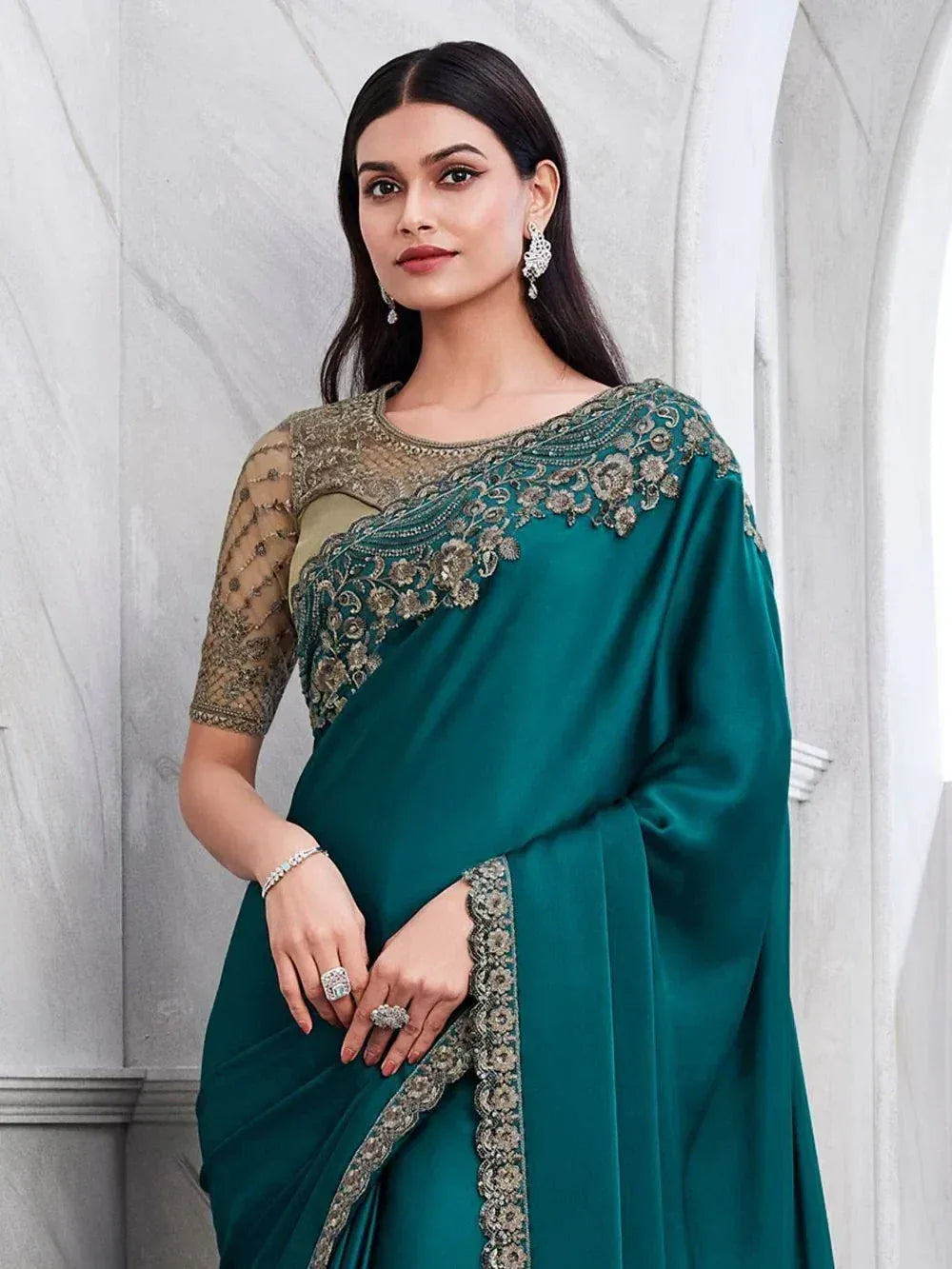 Emerald green designer saree with gold embroidery, perfect for Indian ethnic wear occasions.