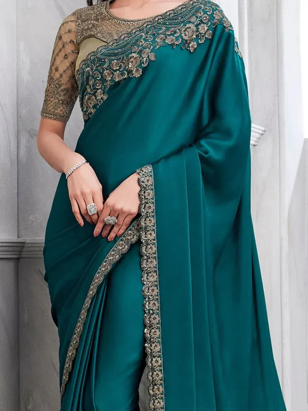 Emerald green designer saree with gold floral embroidery and sheer blouse, perfect for Indian ethnic occasions.