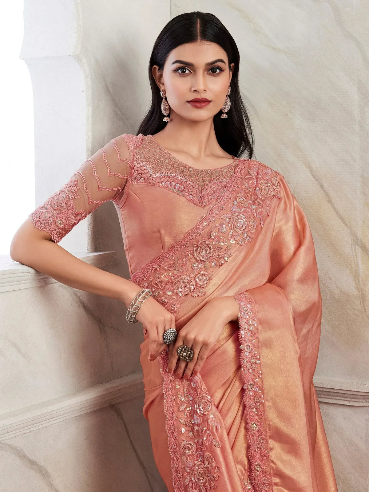 Elegant peach saree with intricate floral embroidery and sheer sleeves, perfect for Indian ethnic occasions.