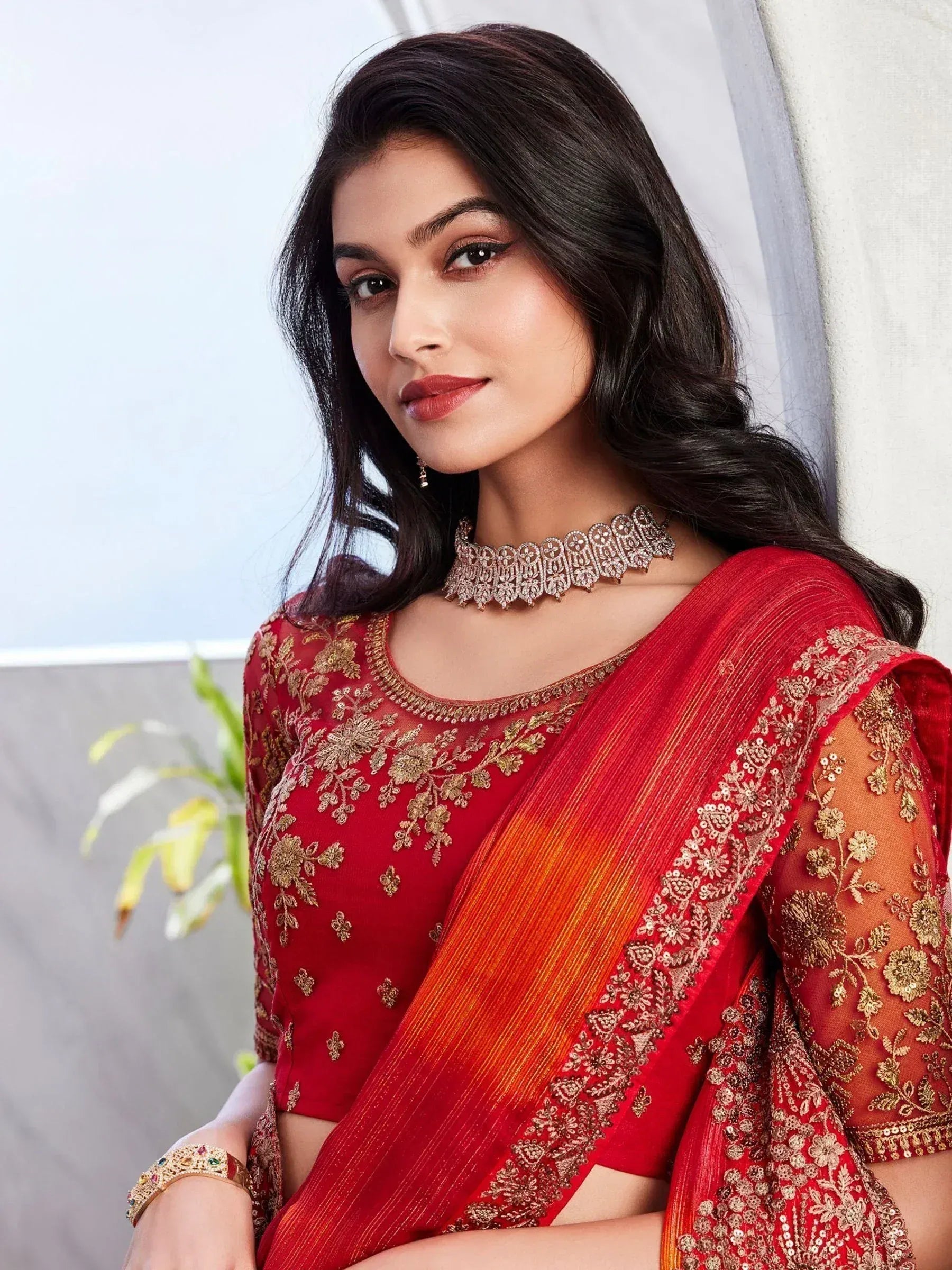 Red and gold embroidered saree with matching blouse, perfect for Indian ethnic occasions and weddings.