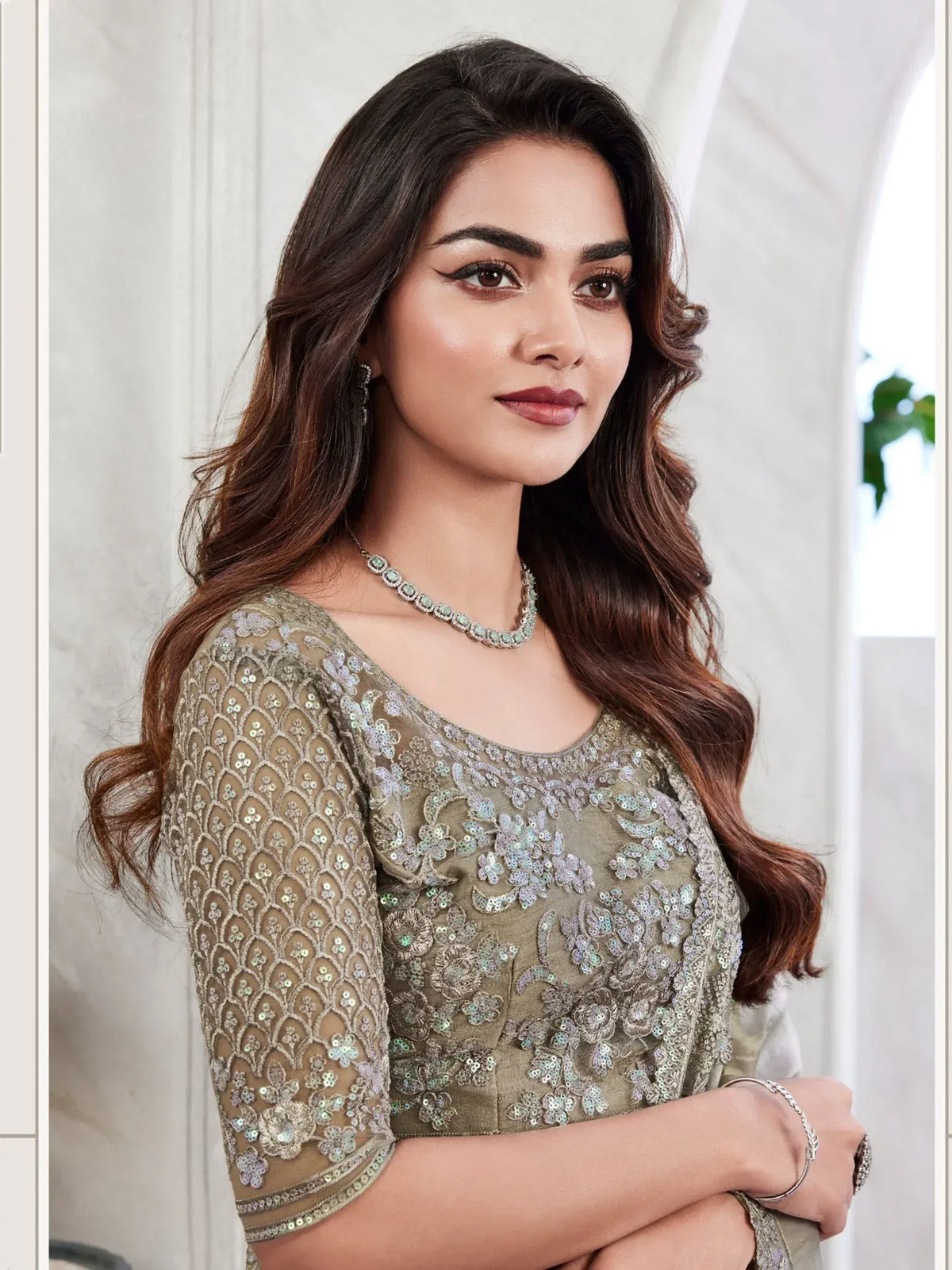 Elegant olive green embroidered ethnic gown with sequin detailing, perfect for Indian festive occasions.