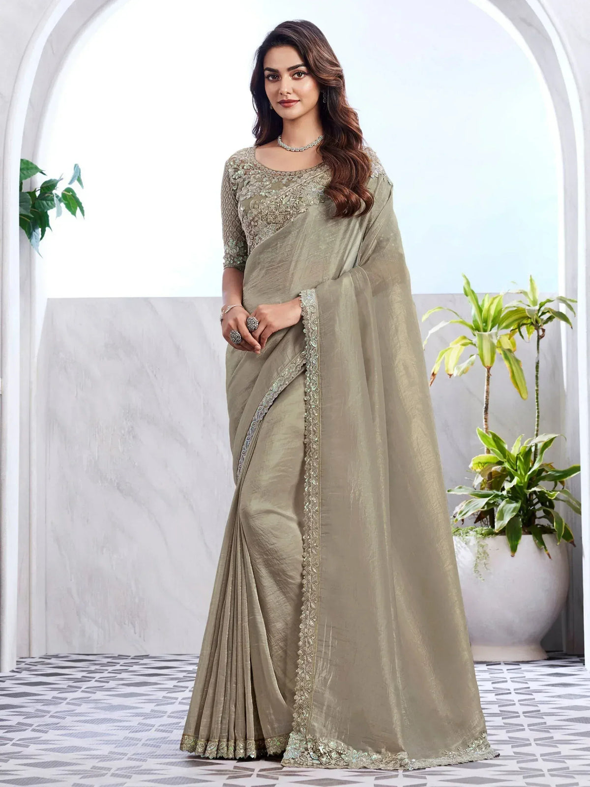 Olive green designer saree with intricate embroidery and embellished border, perfect for ethnic occasions