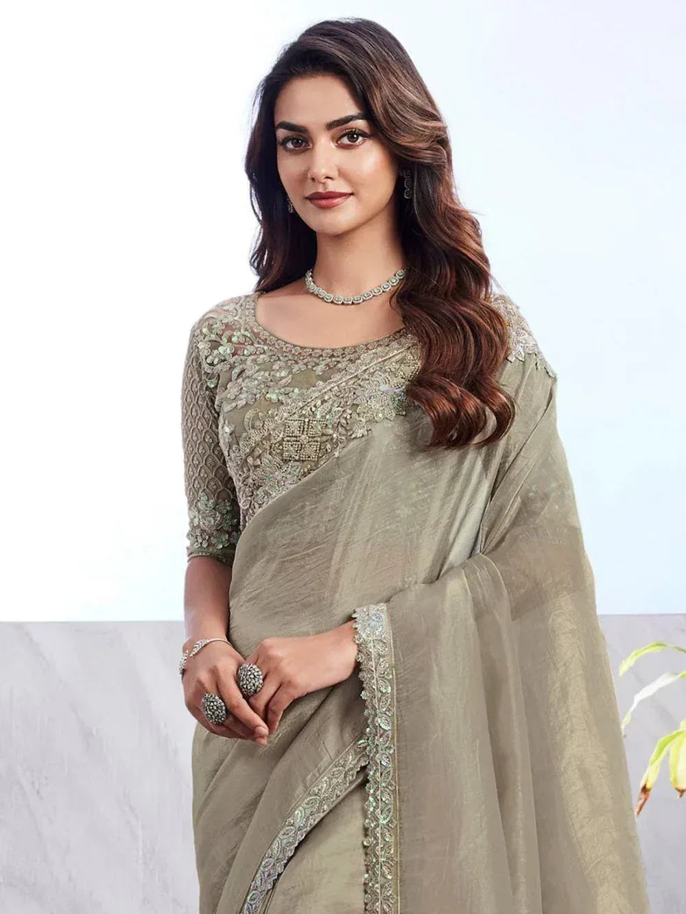 Elegant olive green saree with intricate embroidery and matching blouse, perfect for Indian ethnic occasions.