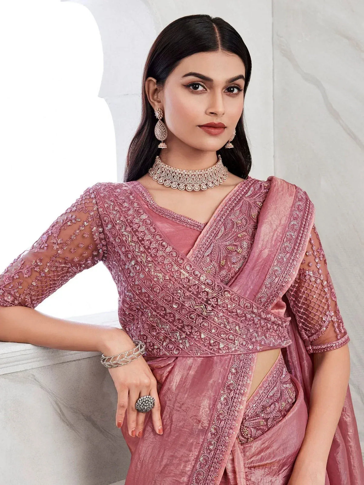 Pink embroidered saree with sheer sleeves and designer jewelry for Indian ethnic wear