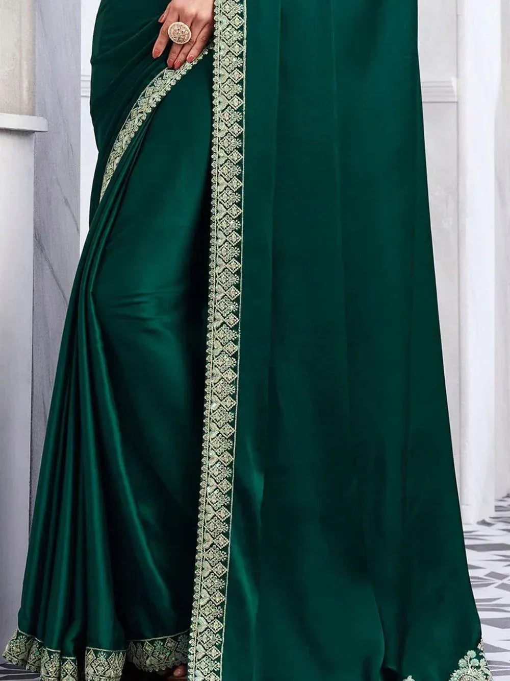 Emerald green satin saree with intricate gold embroidery, perfect for Indian ethnic wear occasions.