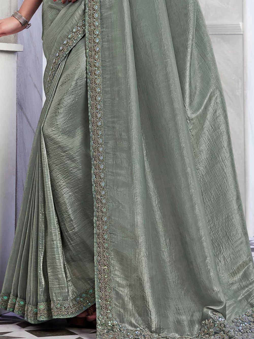Elegant sage green saree with intricate embroidery and shimmering border, perfect for Indian ethnic occasions.