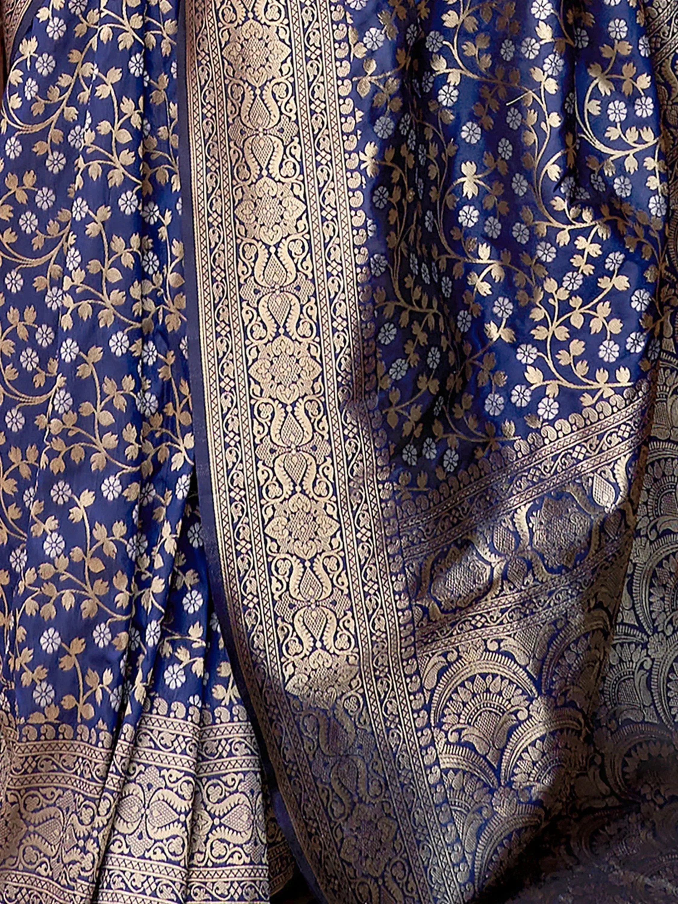 Royal blue ethnic saree with gold floral and paisley brocade, perfect for Indian weddings and festive occasions.