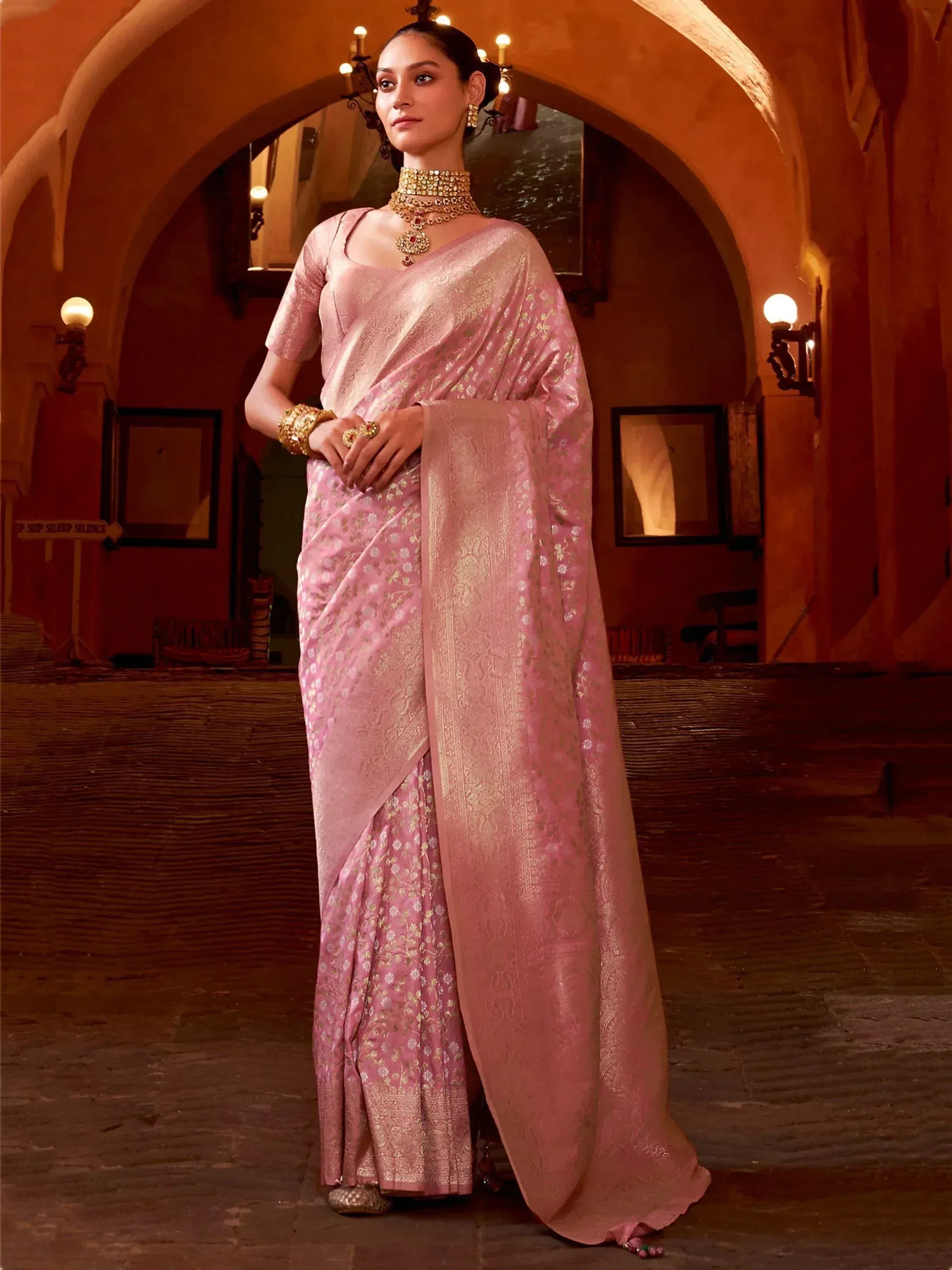 Elegant pink designer saree with gold floral motifs, perfect for Indian ethnic wear and festive occasions.