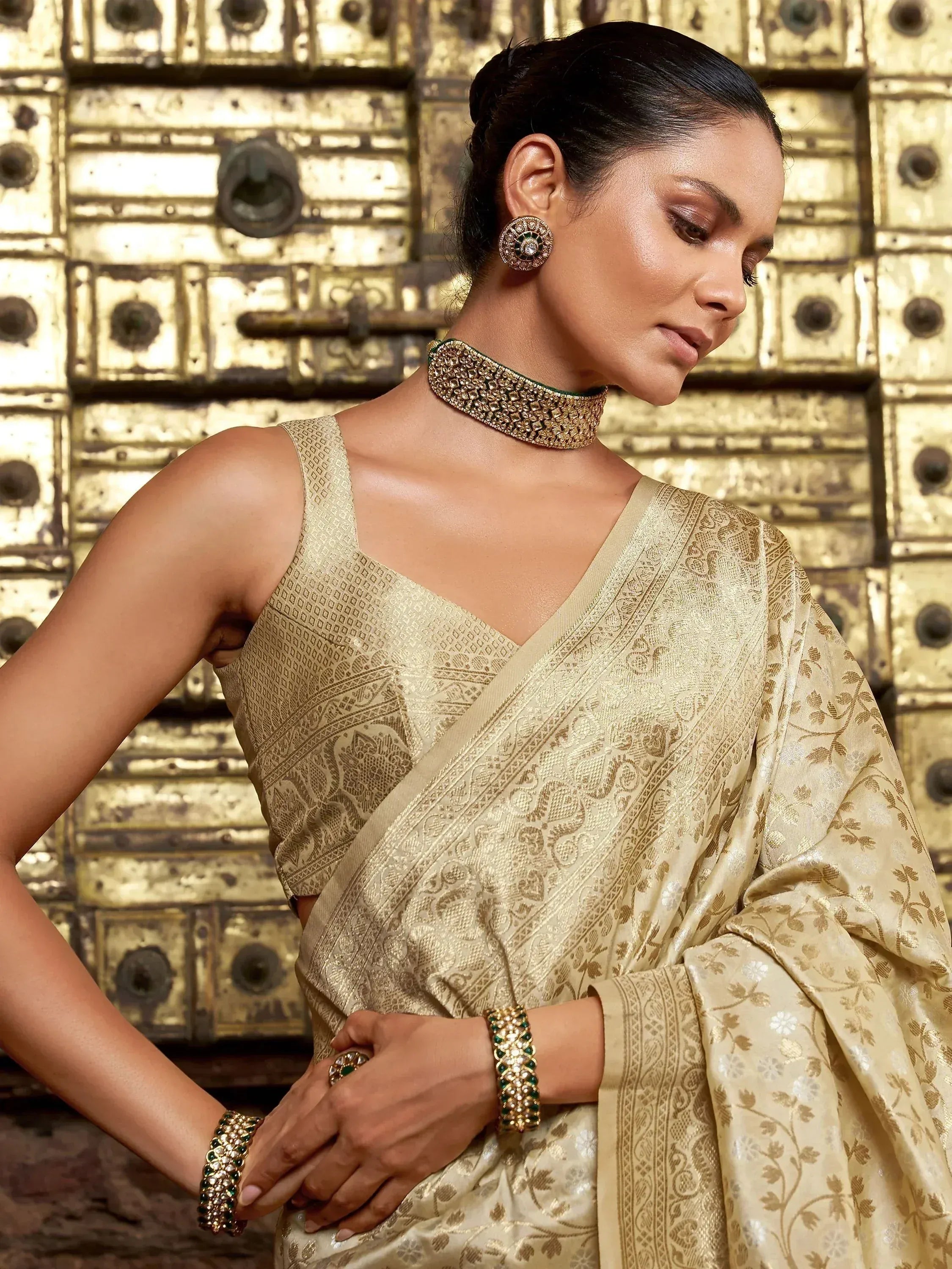 Elegant woman in gold embroidered saree with matching jewelry, traditional Indian ethnic wear