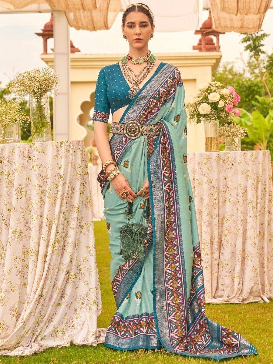 Turquoise designer saree with embroidered border, ethnic blouse, and statement jewelry for Indian weddings