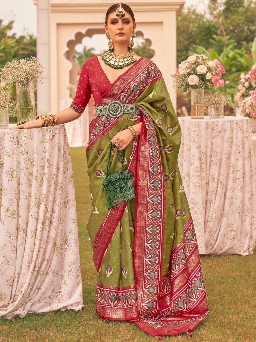 Elegant green and red ethnic saree with intricate embroidery, perfect for Indian weddings and festive occasions.