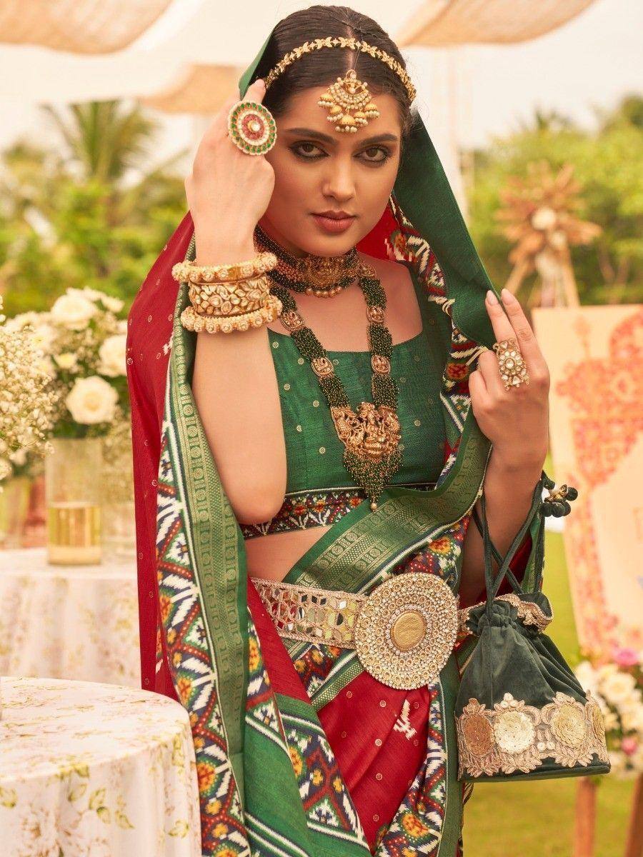 Green and red ethnic lehenga choli with heavy jewelry and dupatta, perfect for Indian weddings