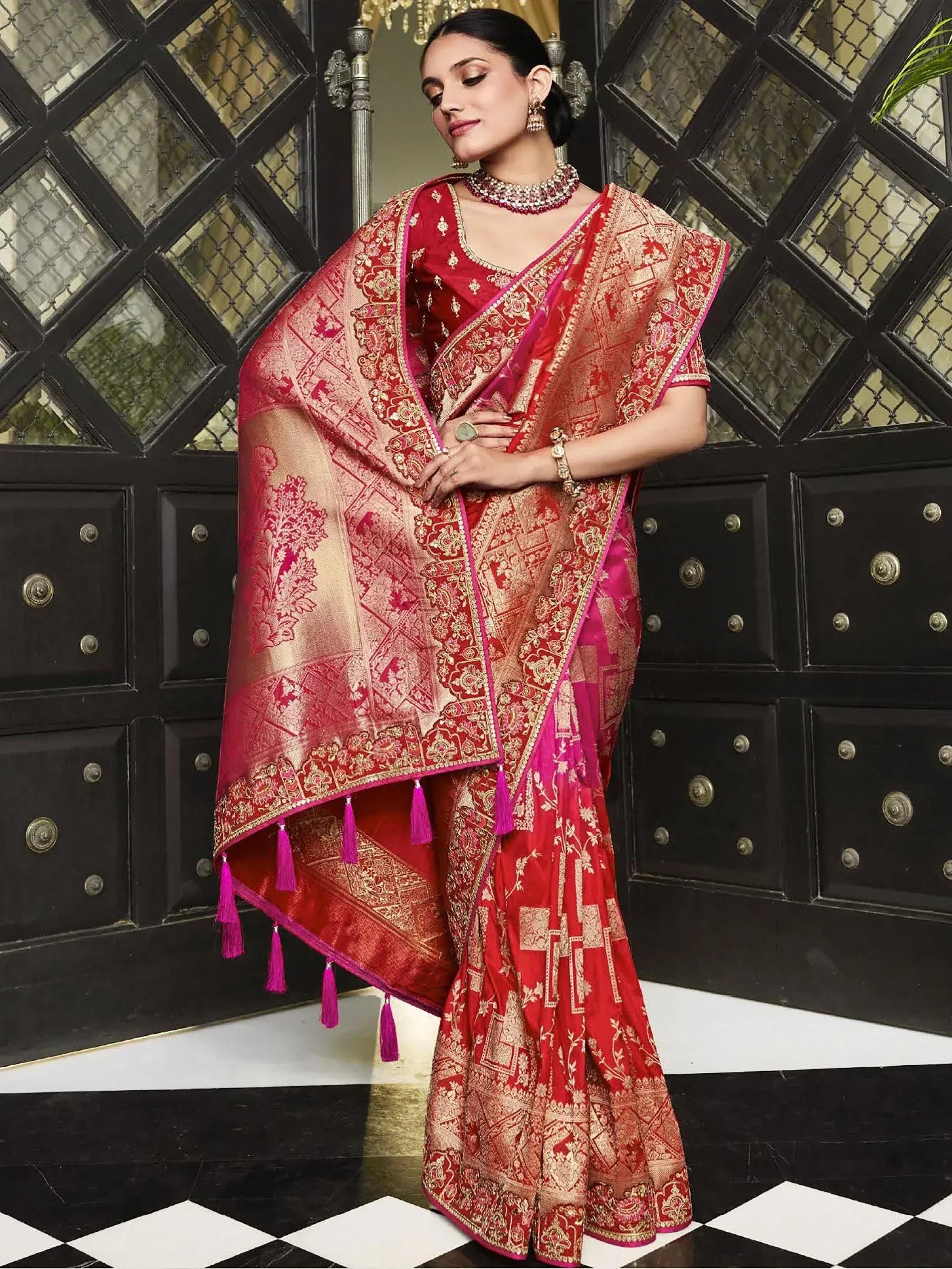 Red and gold designer saree with intricate embroidery and tassels, perfect for Indian ethnic wear occasions