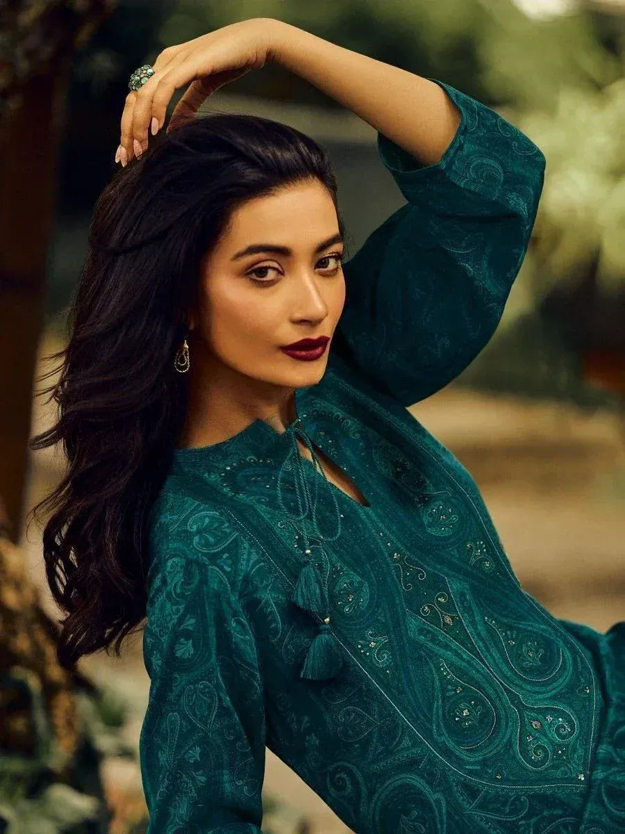 Woman in emerald green ethnic kurta with paisley print and tassel detail, perfect for Indian festive wear