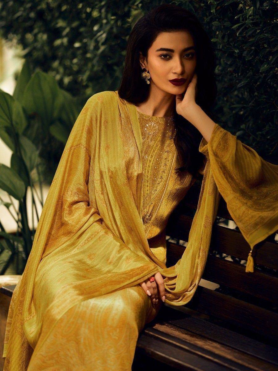 Elegant golden ethnic gown with intricate embroidery, perfect for Indian festive occasions and weddings.