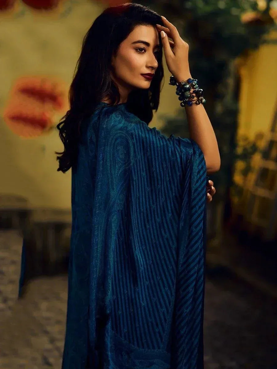 Woman in blue ethnic gown with pleated design, perfect for Indian occasions and festive wear.
