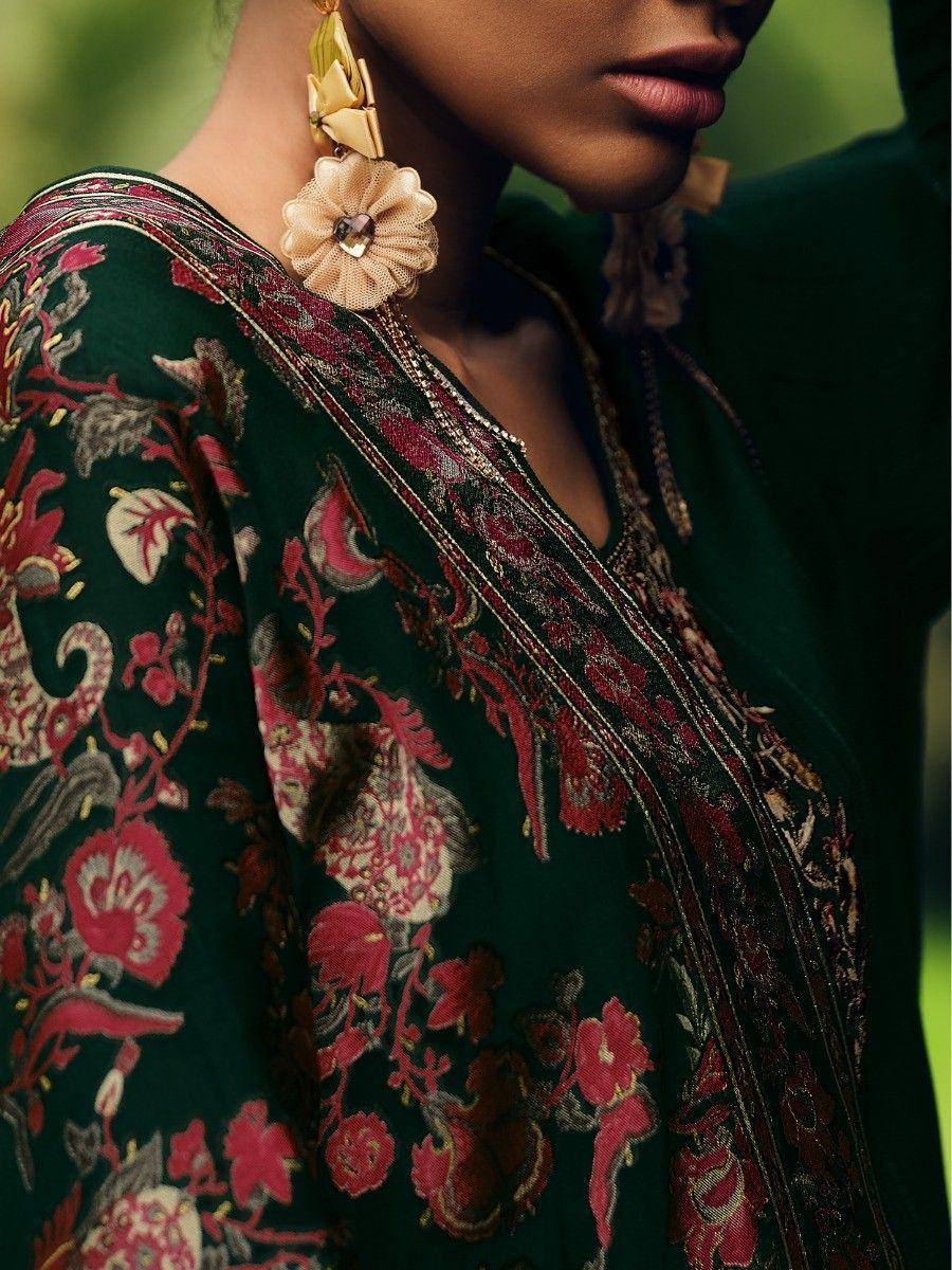 Elegant green embroidered ethnic wear with floral patterns and statement earrings