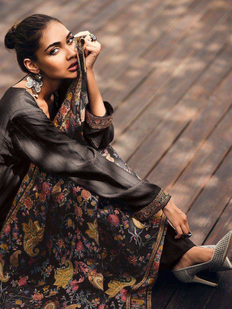 Black floral print ethnic gown with embroidered sleeves, styled with statement earrings and heels