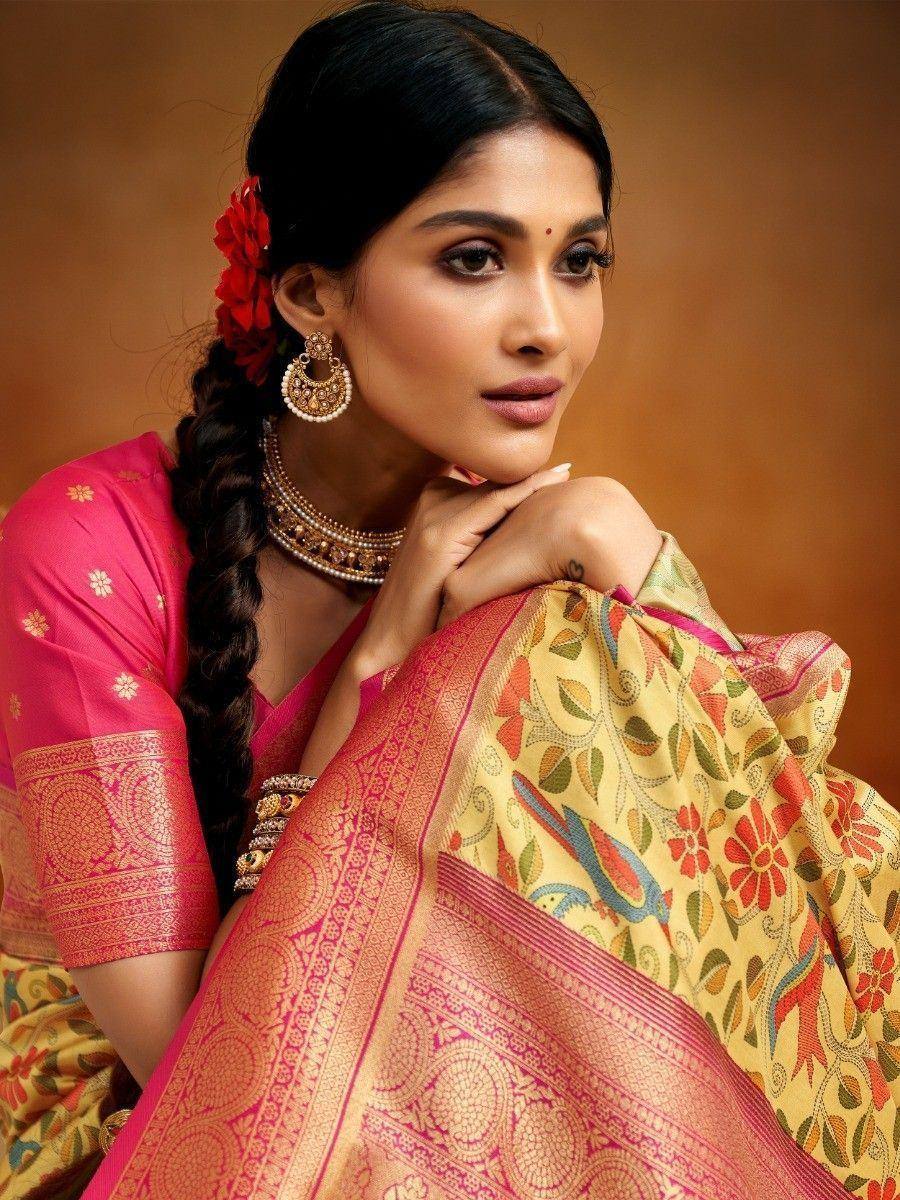 Woman in vibrant pink and gold floral saree with traditional jewelry, perfect for ethnic occasions