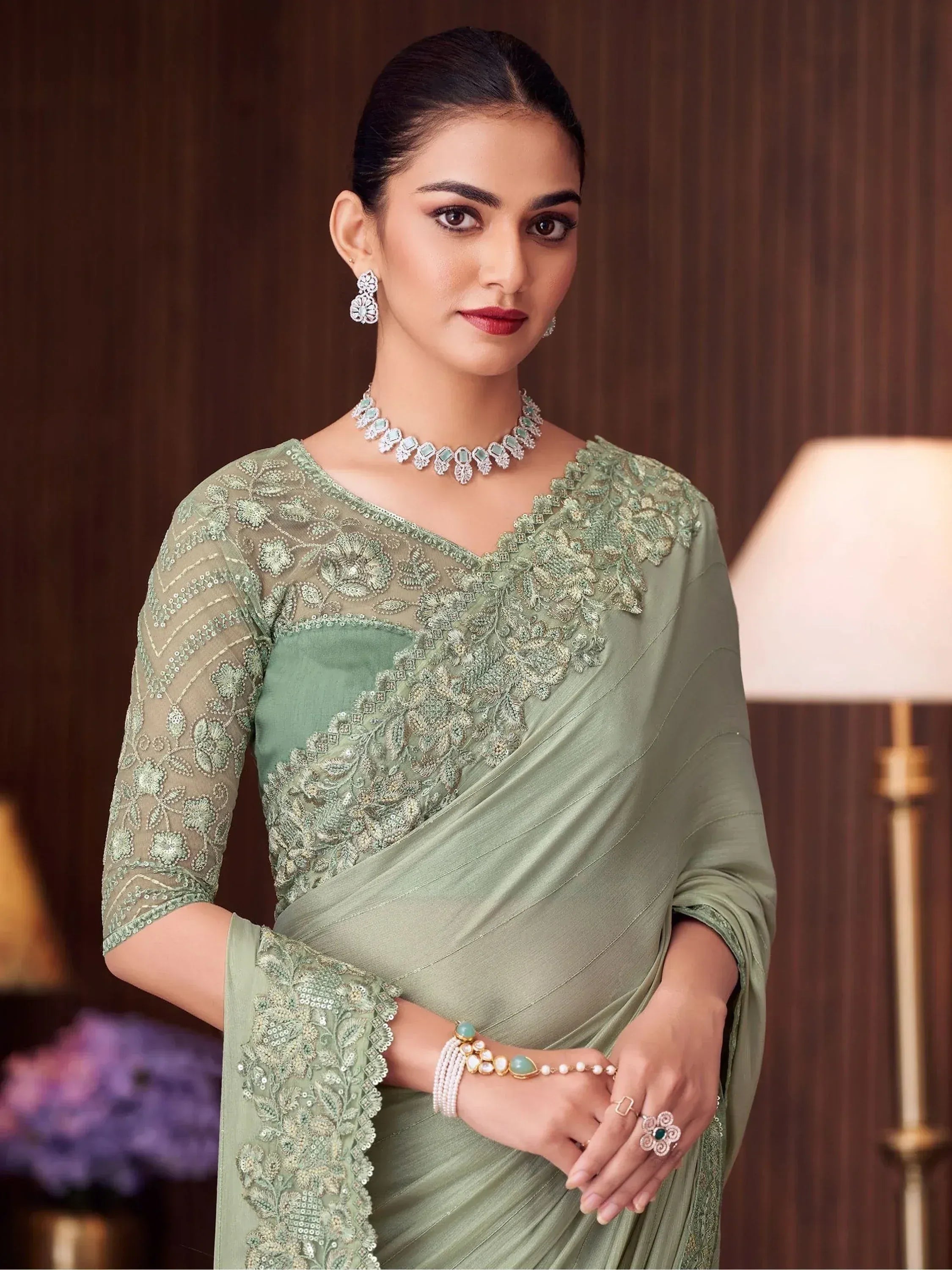 Elegant sage green saree with intricate floral embroidery and matching jewelry for Indian ethnic wear
