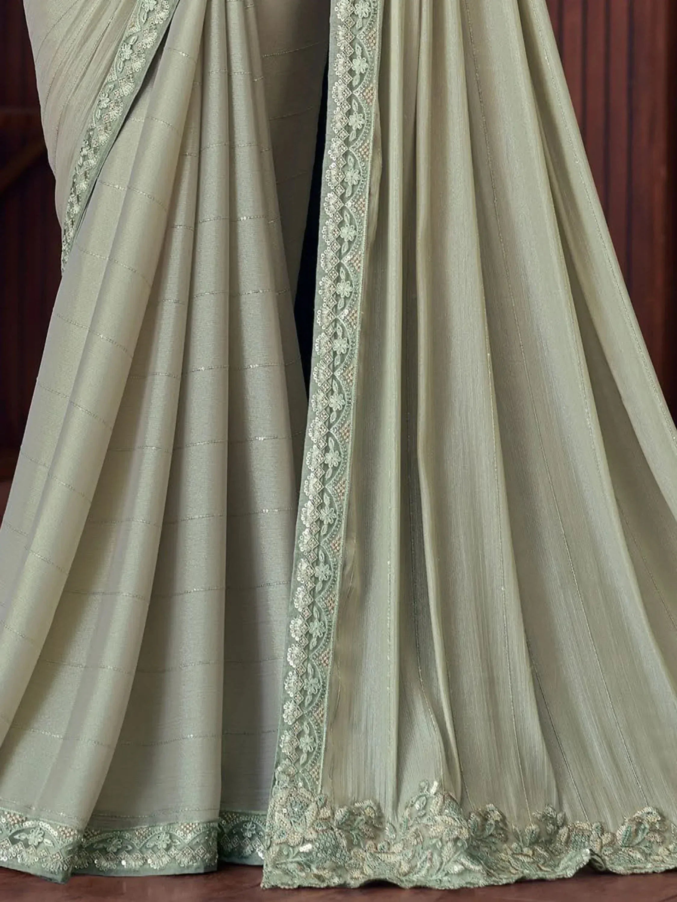 Elegant sage green saree with intricate floral embroidery and sequin detailing, perfect for Indian ethnic occasions.