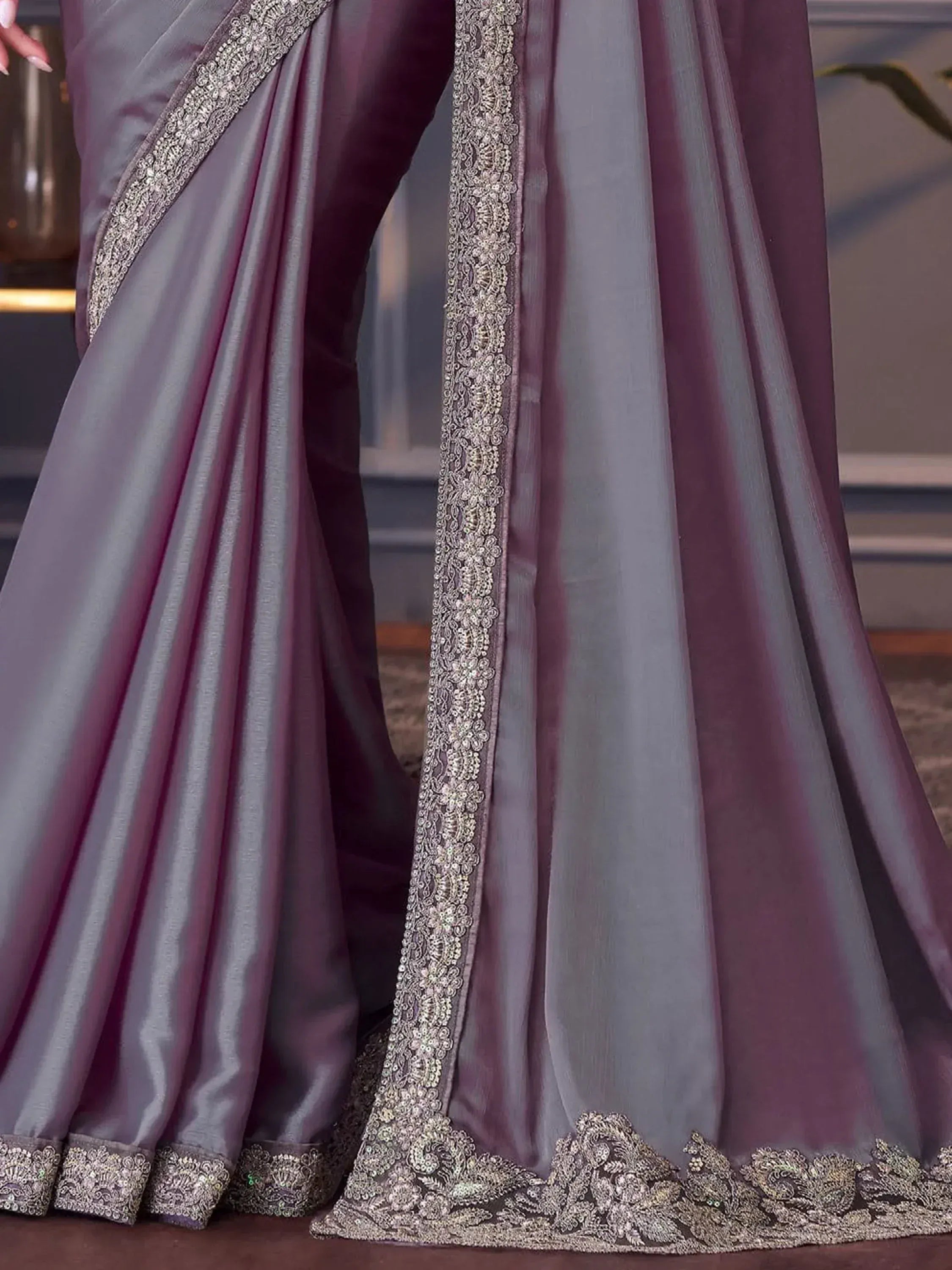Elegant purple-grey saree with intricate silver embroidery and embellished border, perfect for ethnic occasions.