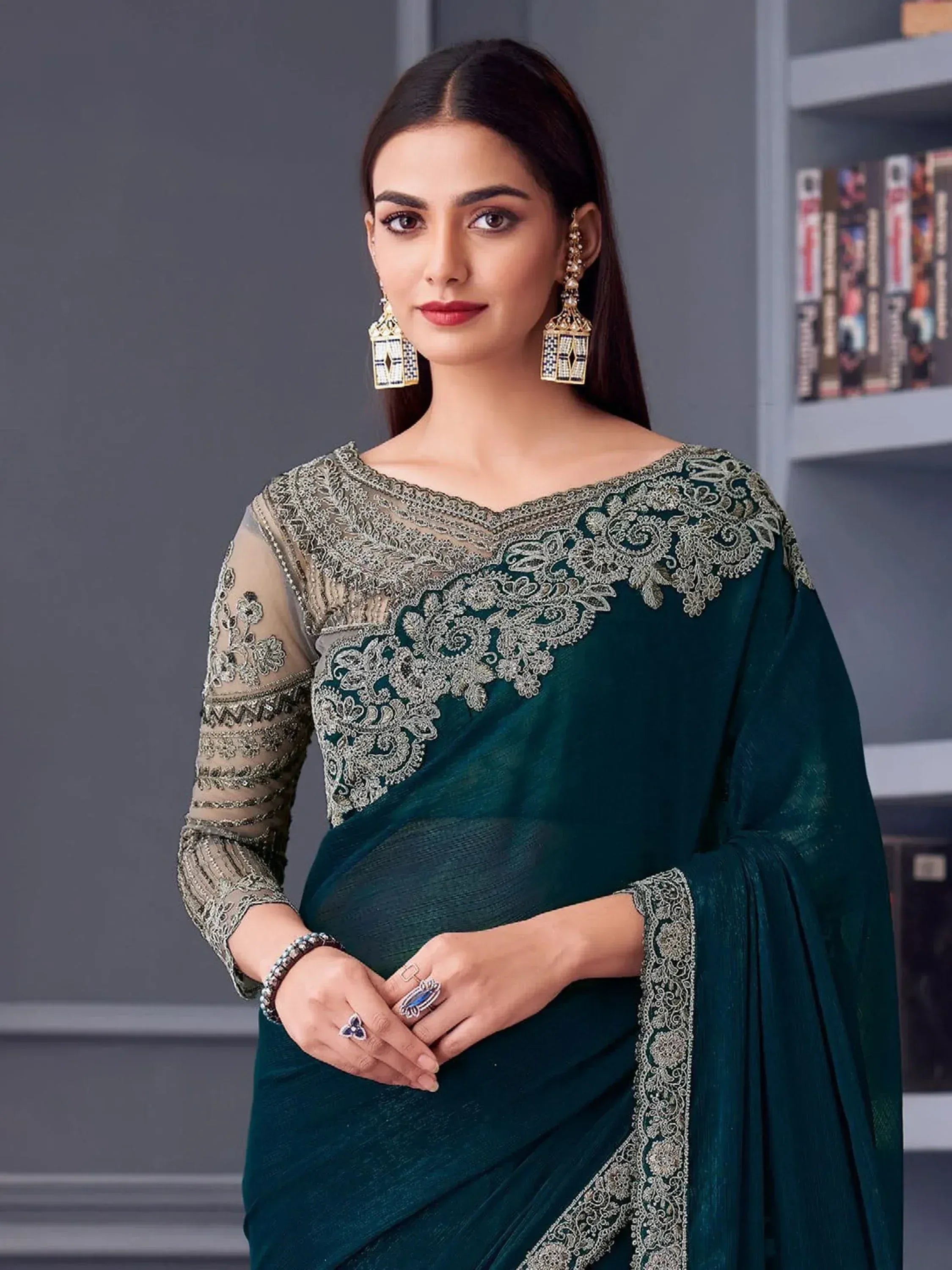Emerald green saree with silver embroidery and sheer blouse, perfect for Indian ethnic occasions.