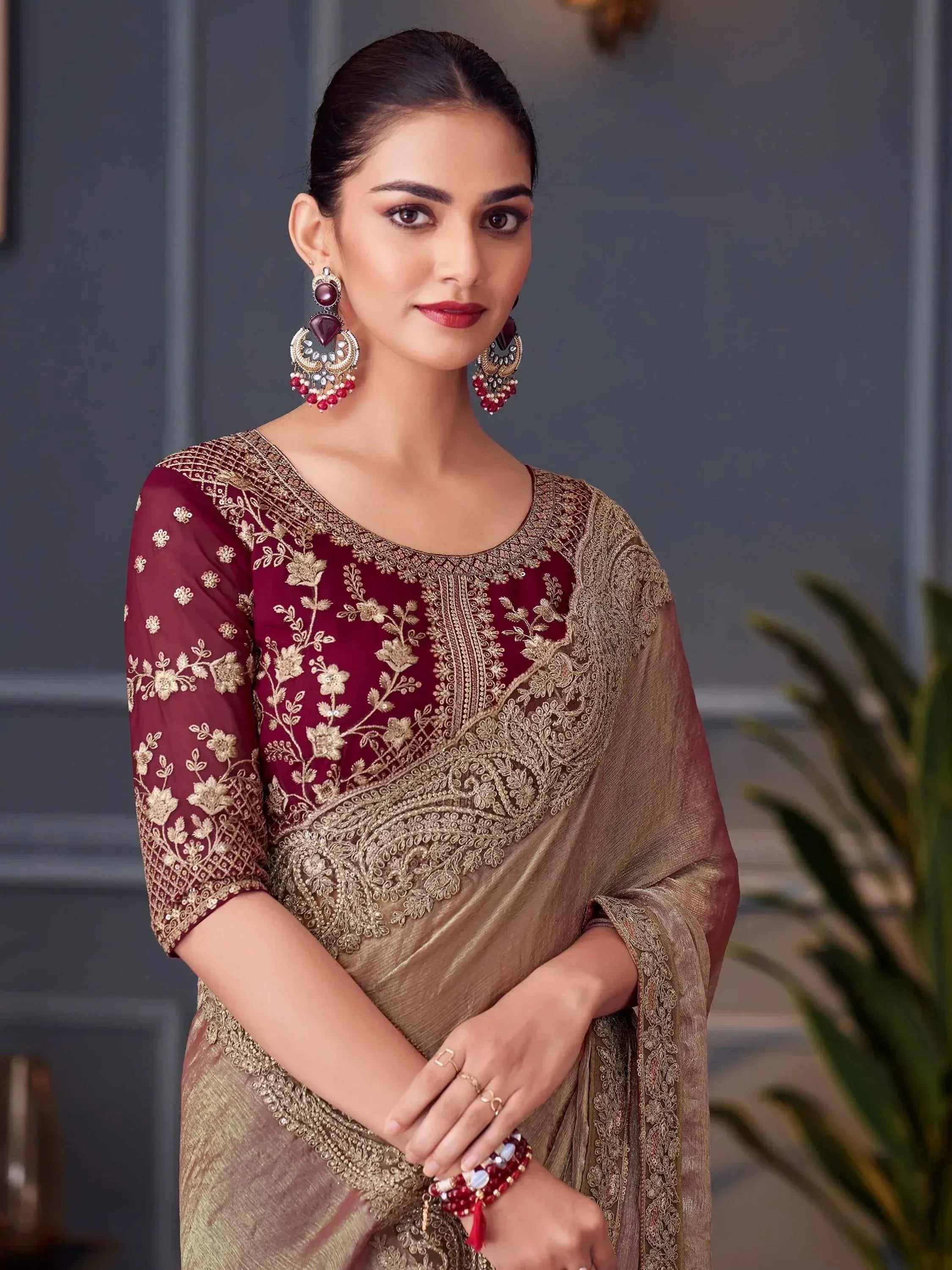 Elegant maroon and gold embroidered saree with floral motifs, perfect for Indian ethnic wear occasions