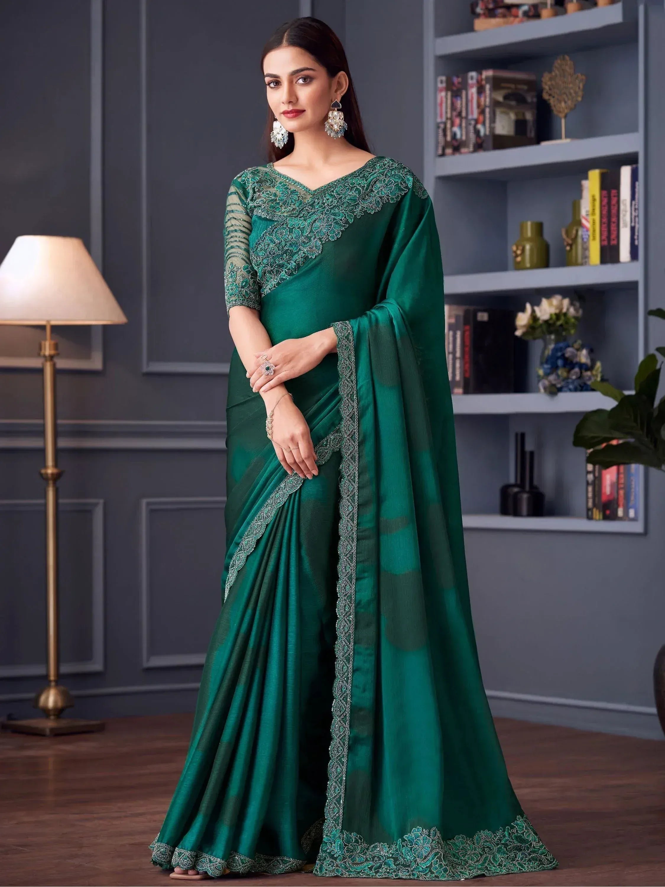 Emerald green designer saree with intricate lace embroidery, perfect for Indian ethnic wear occasions.