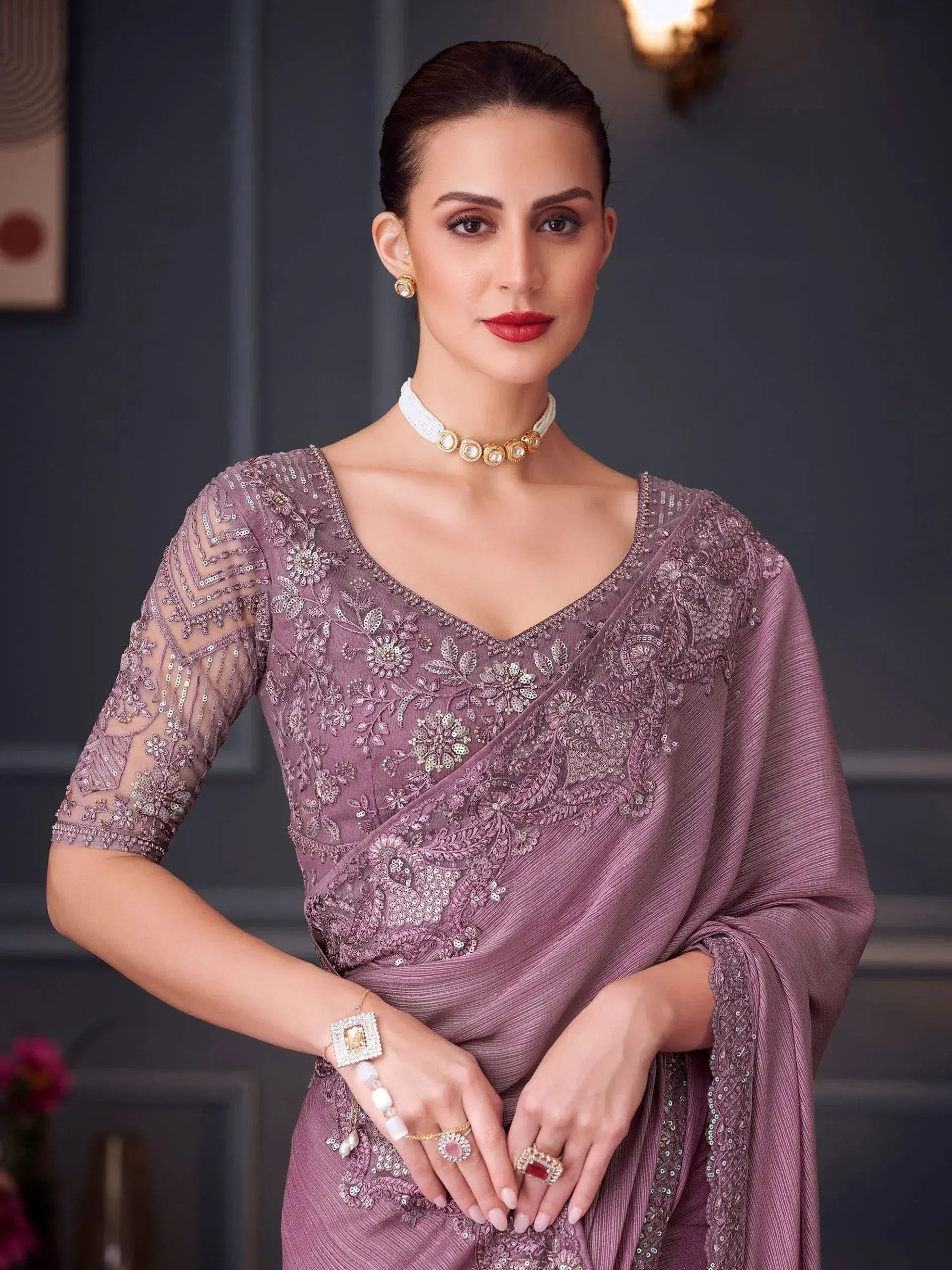 Elegant mauve designer saree with intricate floral embroidery and sequin detailing, perfect for Indian ethnic occasions.