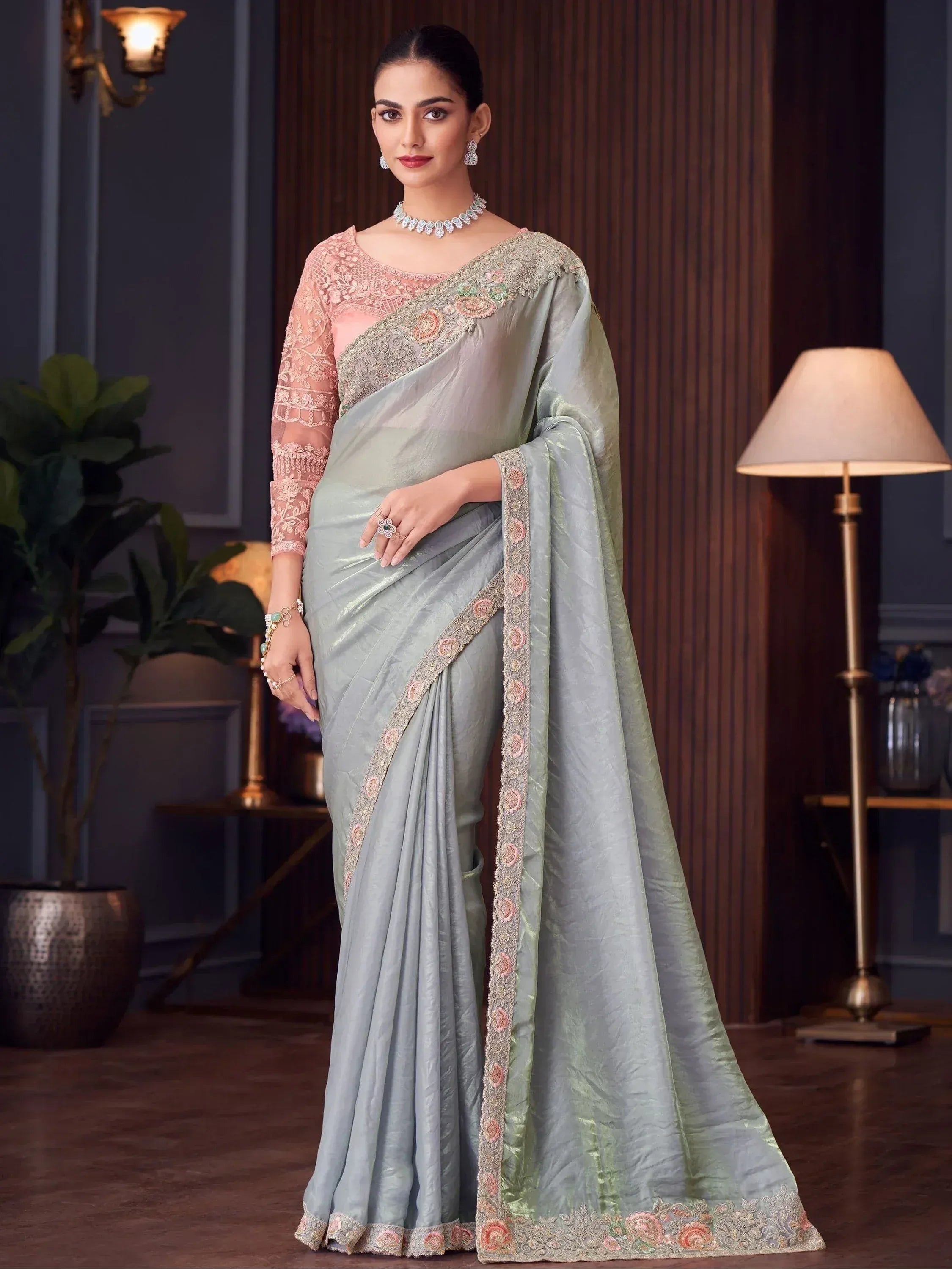 Elegant light green saree with floral embroidery and pink lace blouse, perfect for Indian ethnic occasions