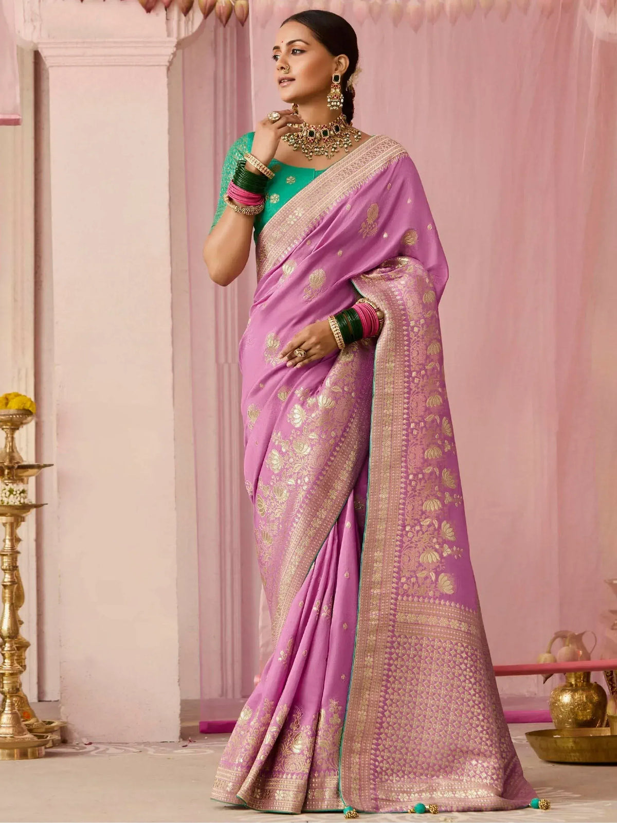 Woman in purple designer saree with gold embroidery, green blouse, traditional Indian ethnic wear