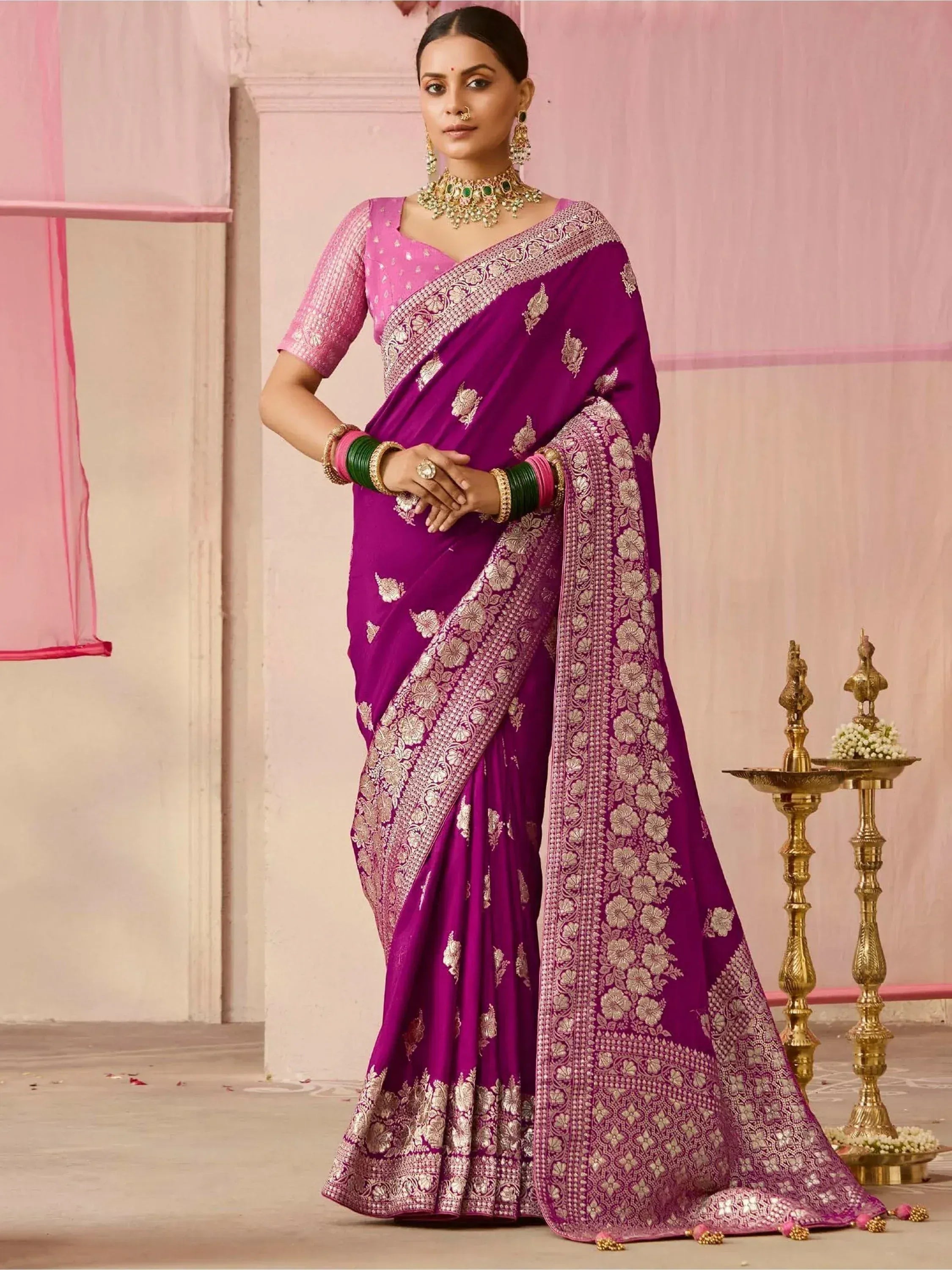 Purple designer saree with gold floral embroidery, paired with pink blouse and traditional jewelry for Indian ethnic wear
